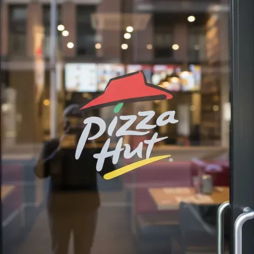 Realistic glass door logo mockup with the uploaded logo as a frosted or semi-transparent decal. Modern glass door with natural reflections and soft lighting. Background softly blurred to match the brand's style—office, café, studio, or boutique. Photorealistic, elegant, and professional presentation.