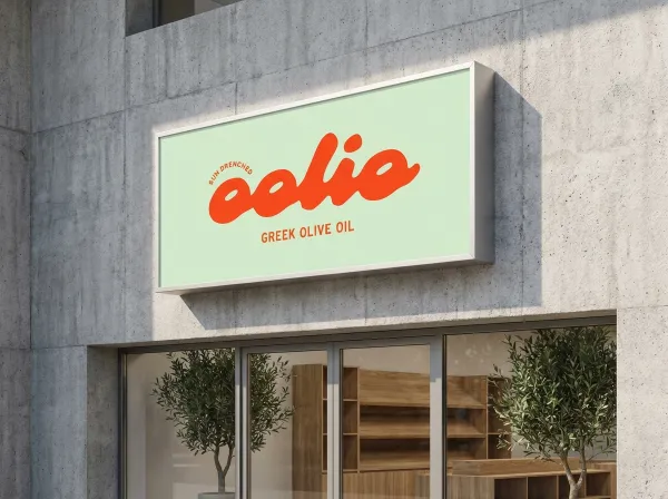 Apply logo to a large rectangular brand-colored lightbox sign on a concrete wall. Modern shop entrance, natural daylight, architectural branding photography.