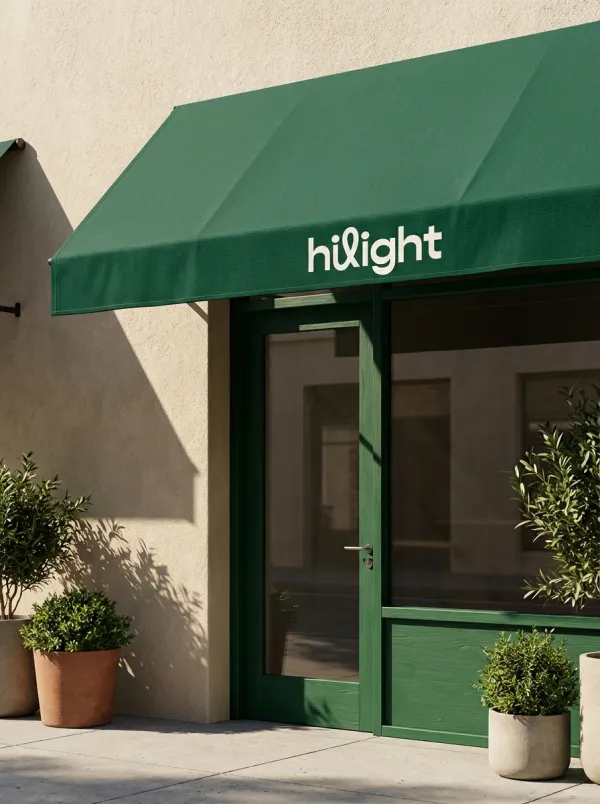 Apply the uploaded logo onto the front edge of a shop awning. Use matching brand colors for the awning and door frame. Photorealistic style, textured beige wall, strong sunlight with sharp shadows, clean architectural photography, 8k.